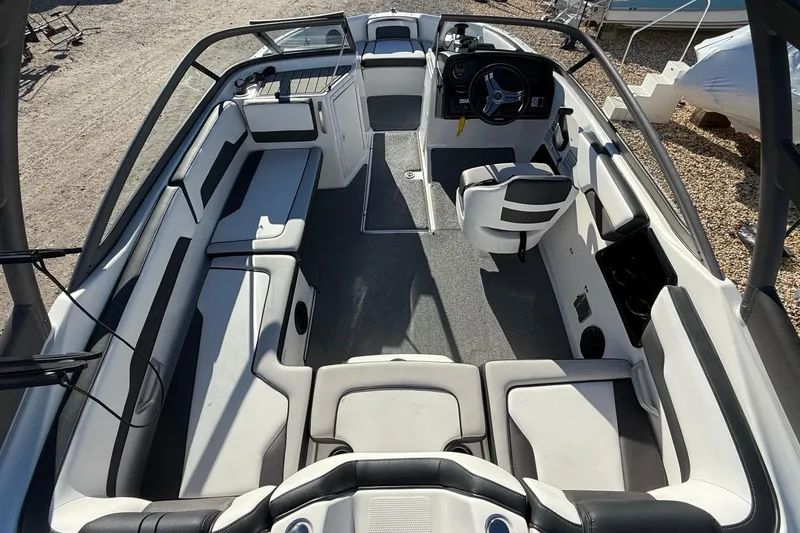 Slide: The Image of 2019 Yamaha Boats AR195 interior with spacious seating and modern dashboard design. - 10