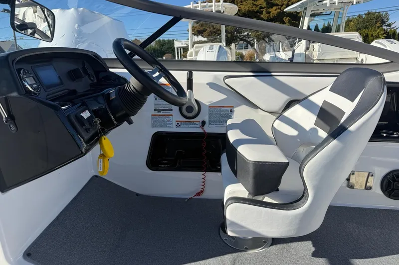 Slide: The Image of 2019 Yamaha Boats AR195 cockpit with steering wheel and captain's chair. - 11