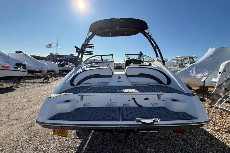 Slide: The Image of 2019 Yamaha Boats AR195, rear view, in a sunny outdoor setting. - 4