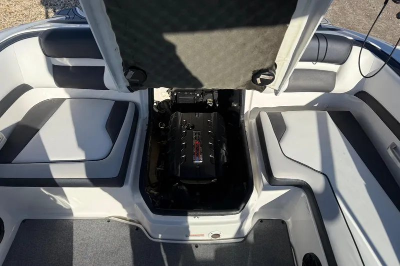 Slide: The Image of 2019 Yamaha Boats AR195 engine compartment with open hatch, showcasing interior seating. - 8