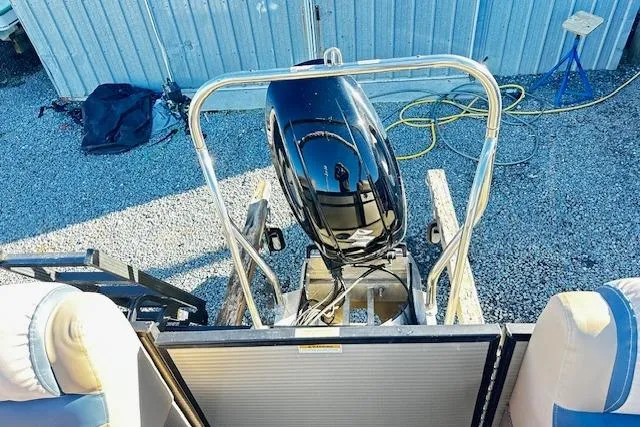 Slide: The Image of 2018 Godfrey Sweetwater 2286 SB Triple Tube boat with outboard motor, parked on gravel. - 17