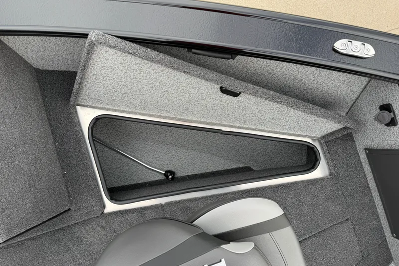 Slide: The Image of 2026 Lund 2075 Fisherman boat interior storage compartment with gray upholstery. - 11