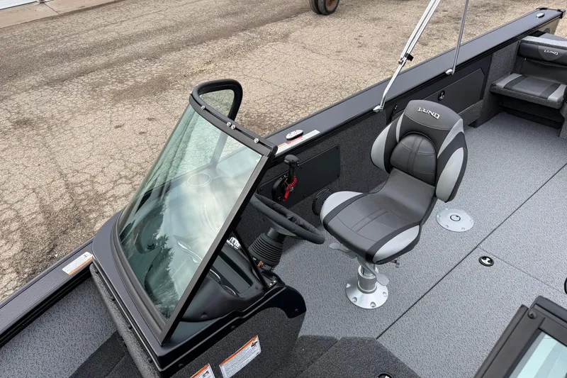 Slide: The Image of 2026 Lund 2075 Fisherman boat interior with steering console and seating. - 14