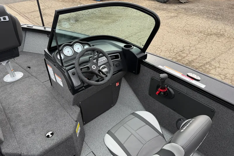 Slide: The Image of 2026 Lund 2075 Fisherman boat interior with steering wheel and seating. - 17