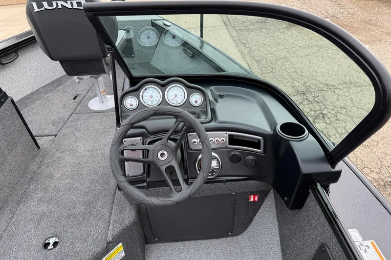 Slide: The Image of 2026 Lund 2075 Fisherman boat dashboard with steering wheel and gauges. - 18