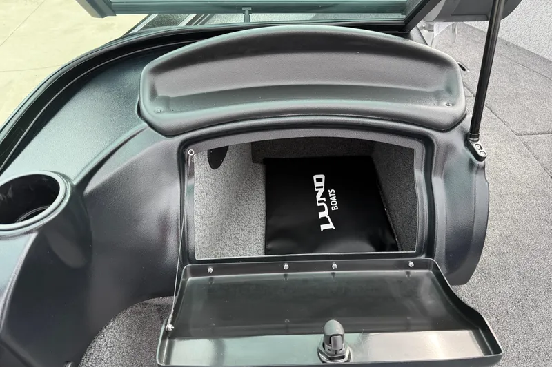 Slide: The Image of 2026 Lund 2075 Fisherman boat storage compartment with open lid, showcasing interior space. - 21