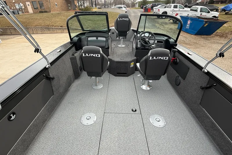 Slide: The Image of 2026 Lund 2075 Fisherman boat interior with three seats and steering console. - 27