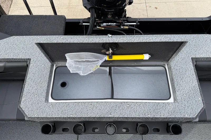 Slide: The Image of 2026 Lund 2075 Fisherman boat livewell with net and motor detail. - 28