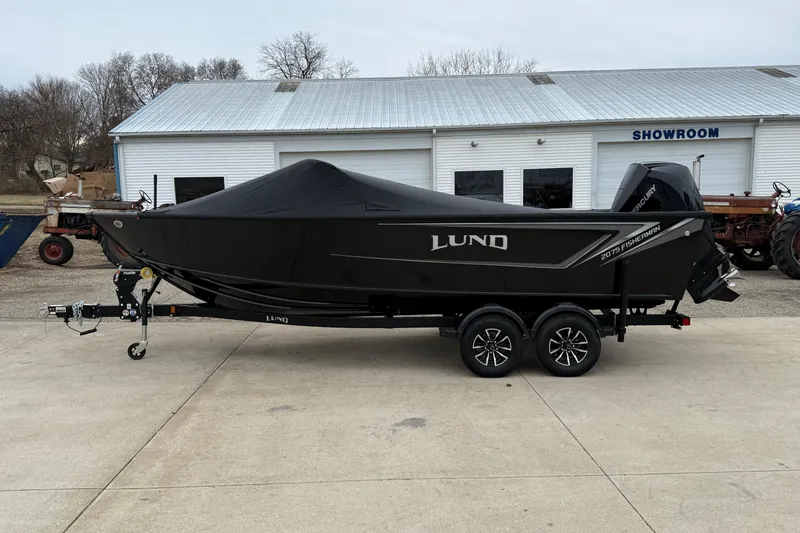 Slide: The Image of 2026 Lund 2075 Fisherman boat on trailer, covered, outside showroom. - 32