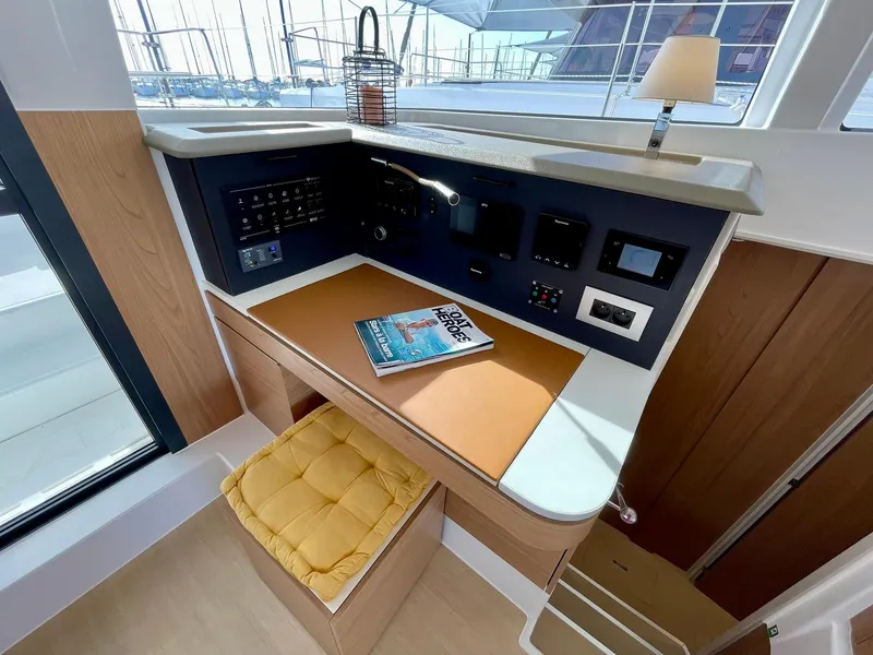 Slide: The Image of Navigation station in a 2026 Bali 4.2 yacht with control panel and seating. - 13