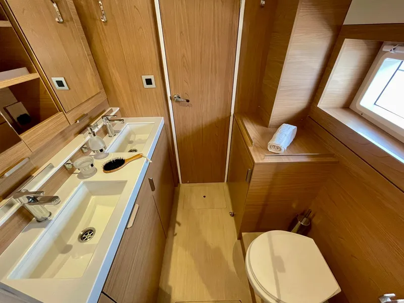 Slide: The Image of Modern bathroom interior in a 2026 Bali 4.2 yacht, featuring wood accents and dual sinks. - 17