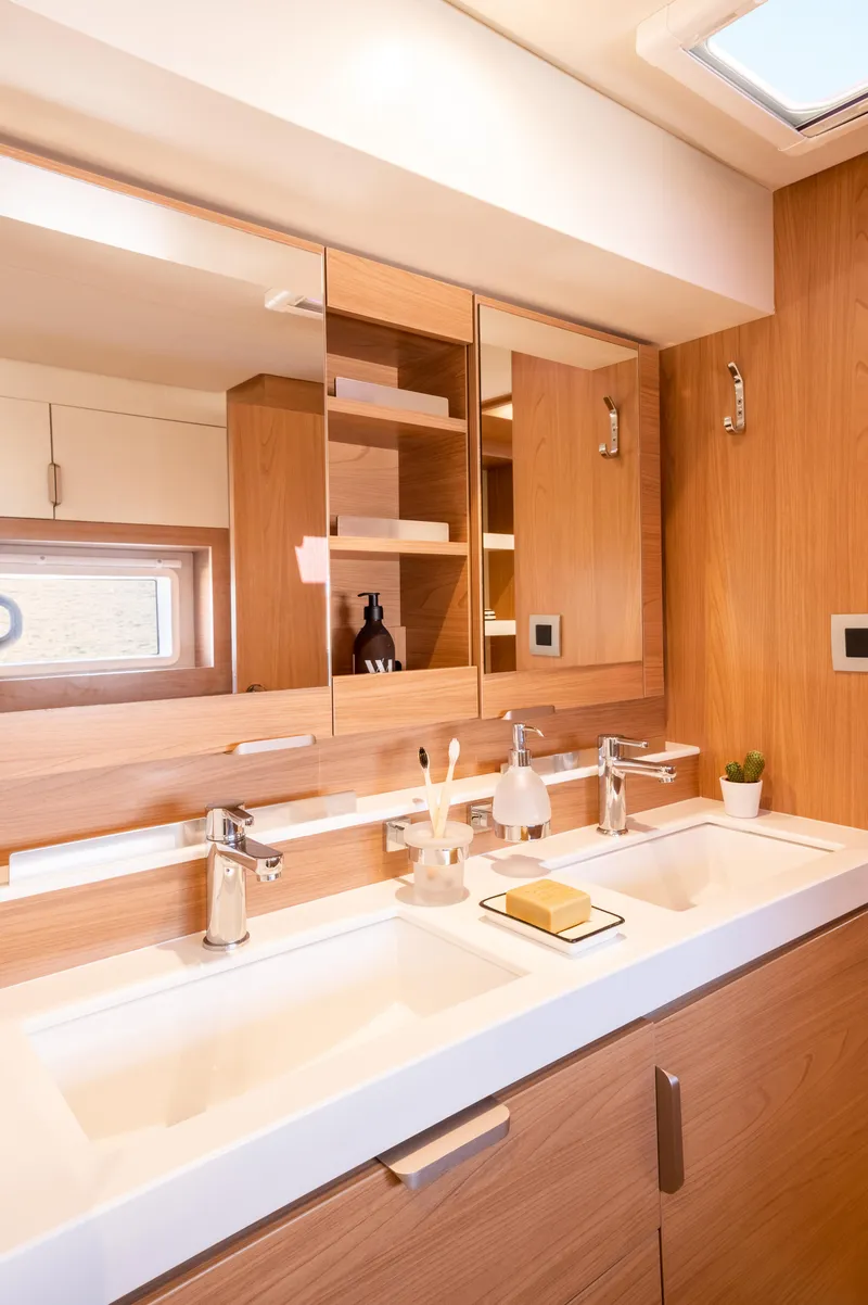 Slide: The Image of Modern bathroom in 2026 Bali 4.2 yacht with dual sinks and wooden cabinetry. - 19
