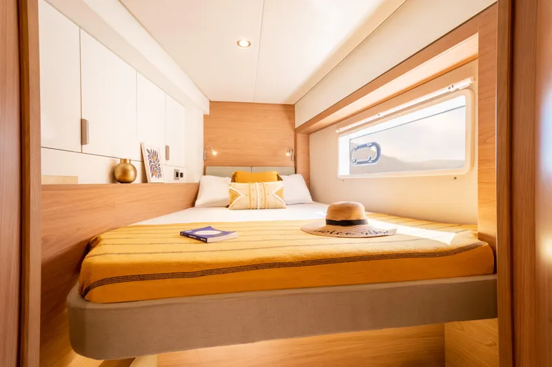 Slide: The Image of Cozy cabin interior of 2026 Bali 4.2 yacht with bed, window, and decor. - 23