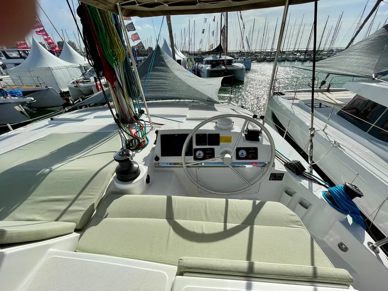 Slide: The Image of Steering area of a 2026 Bali 4.2 yacht at a marina, surrounded by boats. - 28