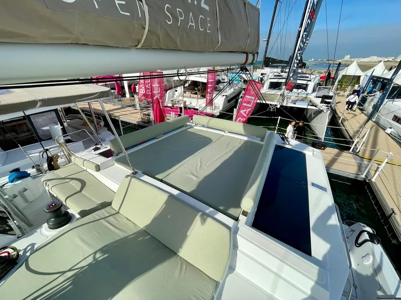 Slide: The Image of Modern Bali 4.2 catamaran deck, 2026 model, docked at marina with sunbathing area. - 29