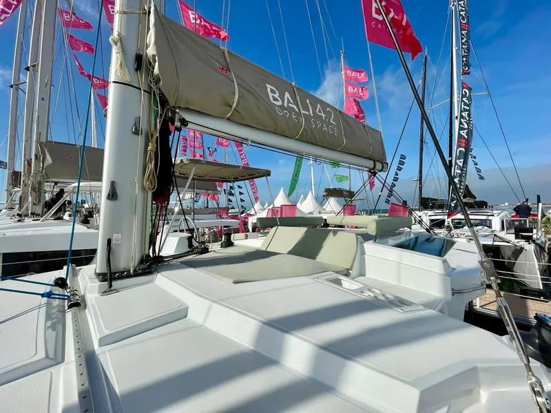 Slide: The Image of Modern Bali 4.2 catamaran at a boat show, showcasing sleek design and spacious deck, 2026 model. - 30