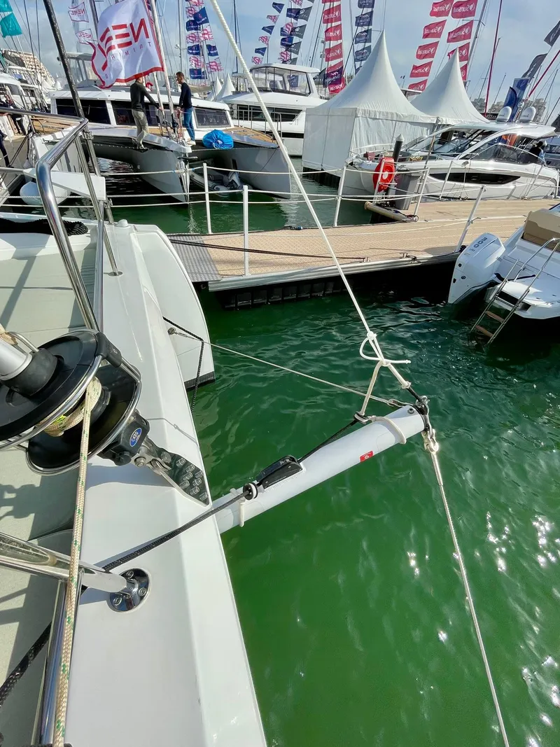 Slide: The Image of Bali 4.2 yacht docked at marina with flags and tents, 2026 model. - 33