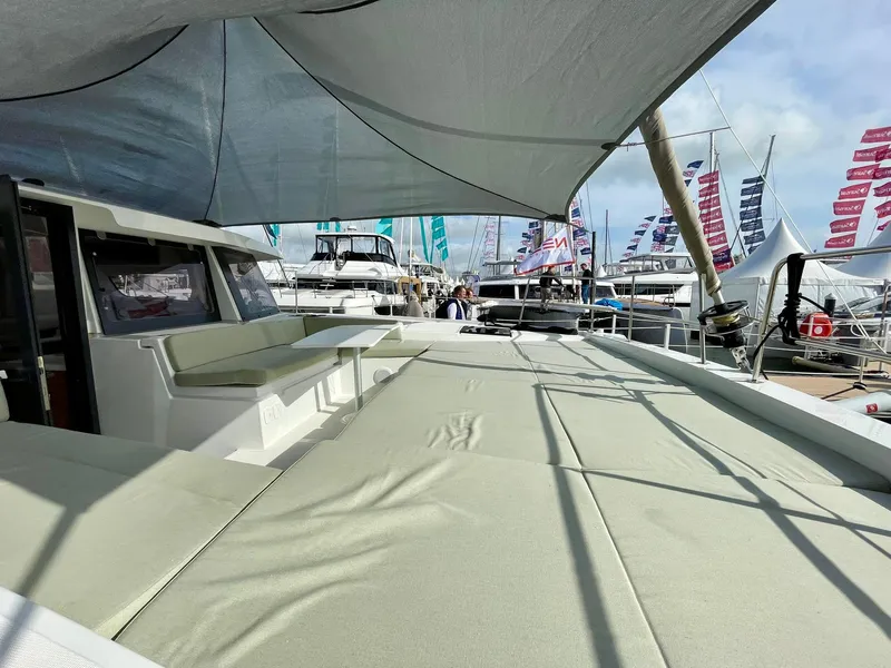 Slide: The Image of Modern Bali 4.2 catamaran deck with seating, 2026 model, at a boat show. - 36