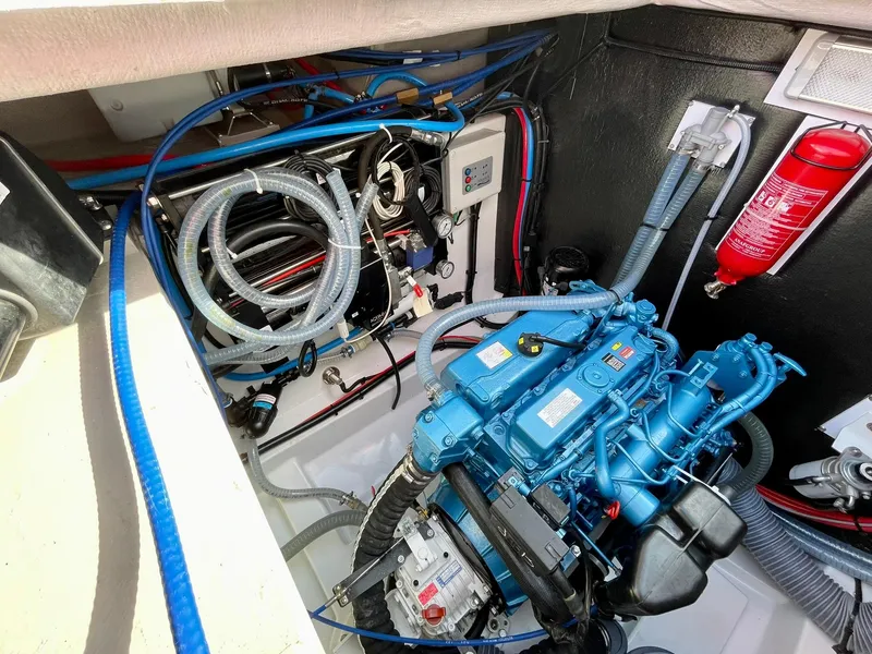 Slide: The Image of Engine compartment of a 2026 Bali 4.2 boat, featuring a blue engine and fire extinguisher. - 39