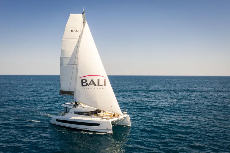 Slide: The Image of 2026 Bali 4.2 catamaran sailing on open sea under clear blue sky. - 48