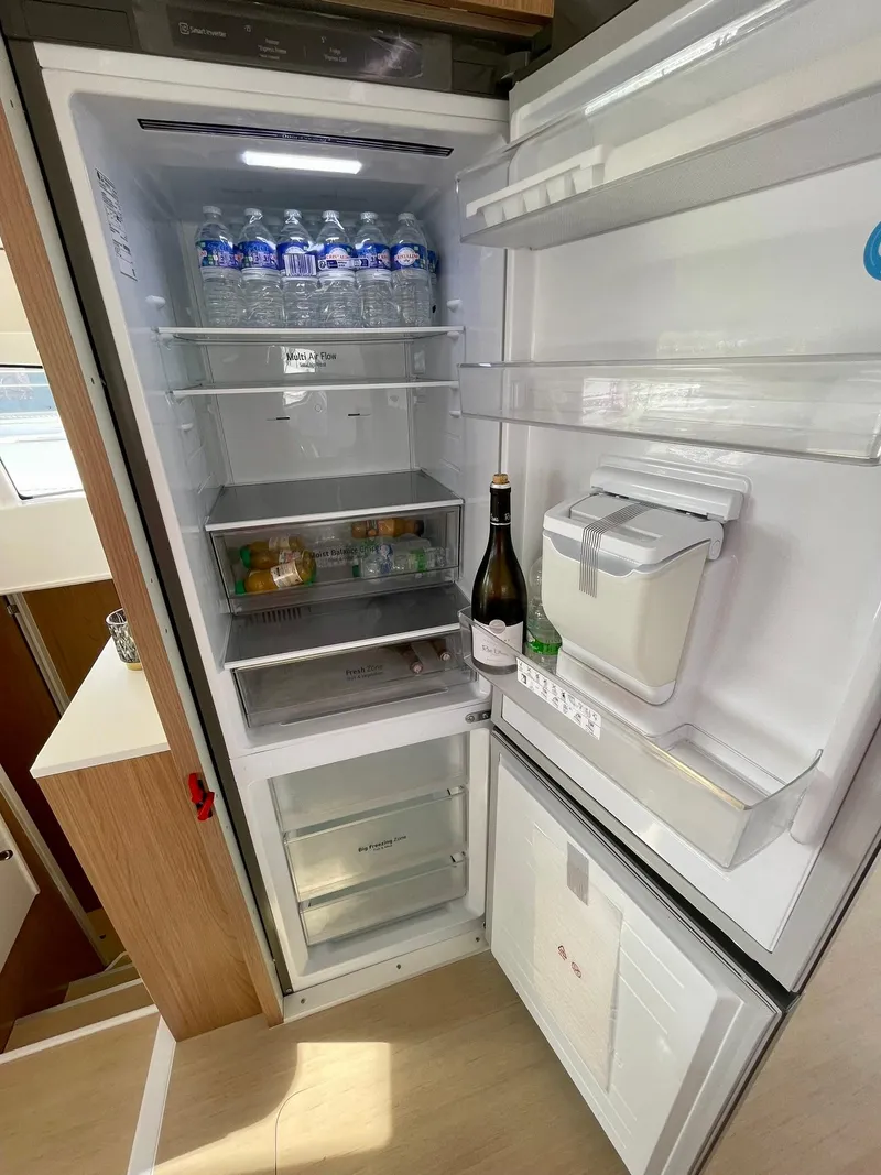 Slide: The Image of Open refrigerator with drinks and ice maker, inside a Bali 4.2 model, 2026. - 6