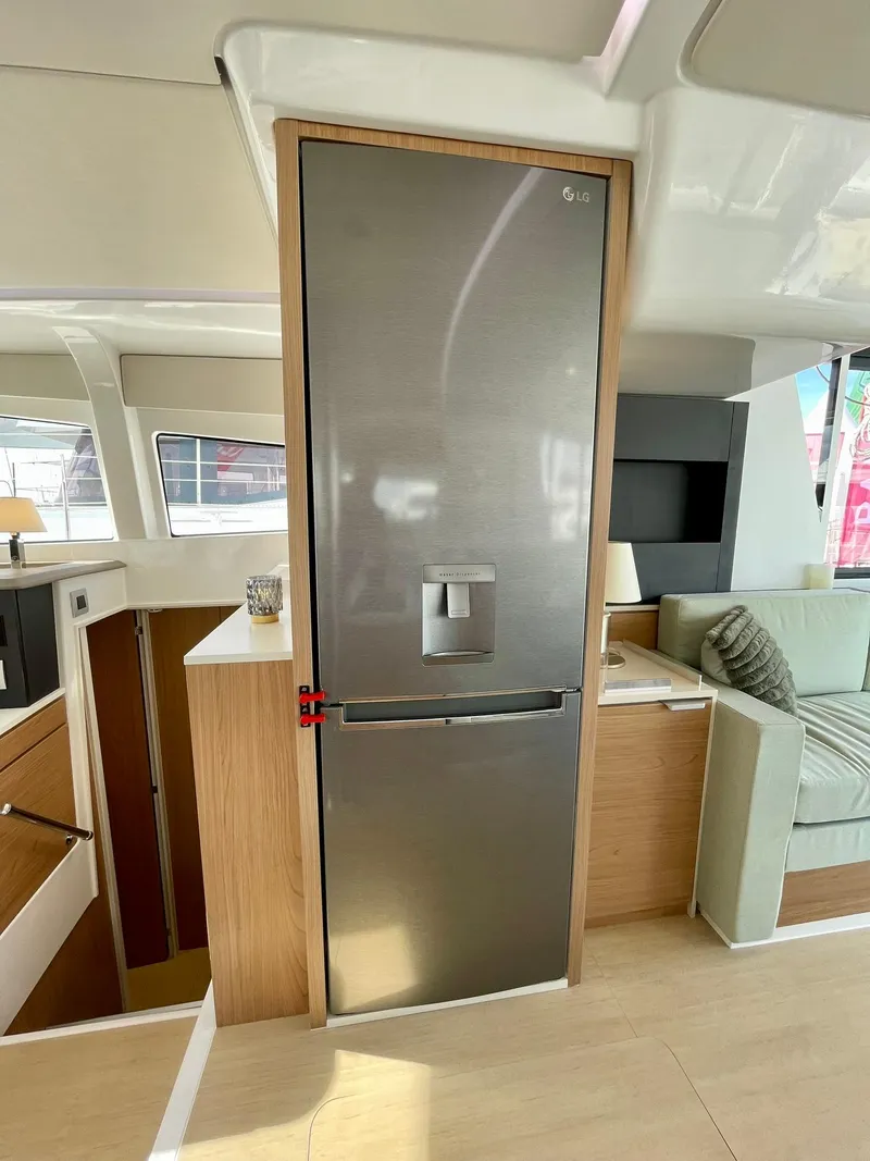 Slide: The Image of Modern kitchen area in a 2026 Bali 4.2 yacht with a sleek stainless steel refrigerator. - 7