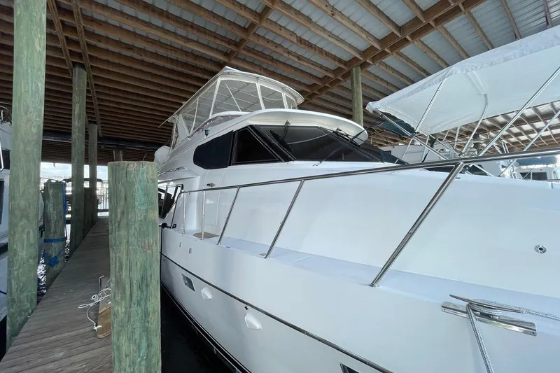 Slide: The Image of 1999 McKinna 57 Pilothouse yacht docked under blue sky. - 10
