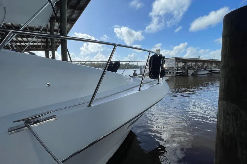 Slide: The Image of 1999 McKinna 57 Pilothouse yacht docked in a marina, rear view. - 11