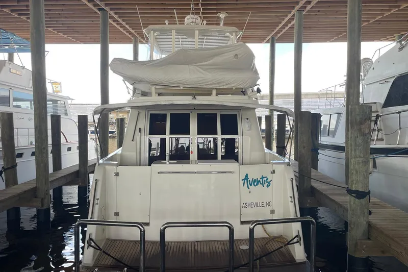 Slide: The Image of 1999 McKinna 57 Pilothouse yacht deck with teak flooring and storage cabinets. - 12