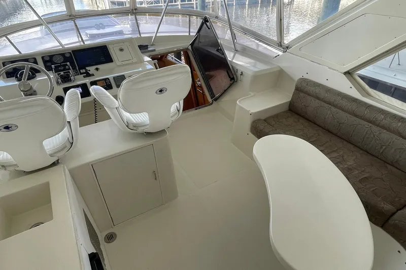 Slide: The Image of 1999 McKinna 57 Pilothouse yacht interior with helm, seating, and navigation equipment. - 17