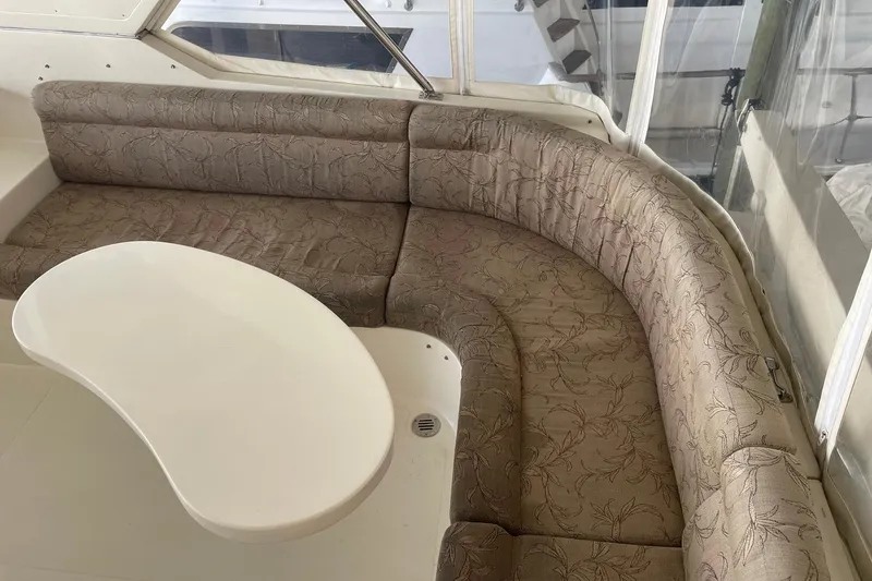 Slide: The Image of 1999 McKinna 57 Pilothouse helm view with marina backdrop and clear skies. - 21