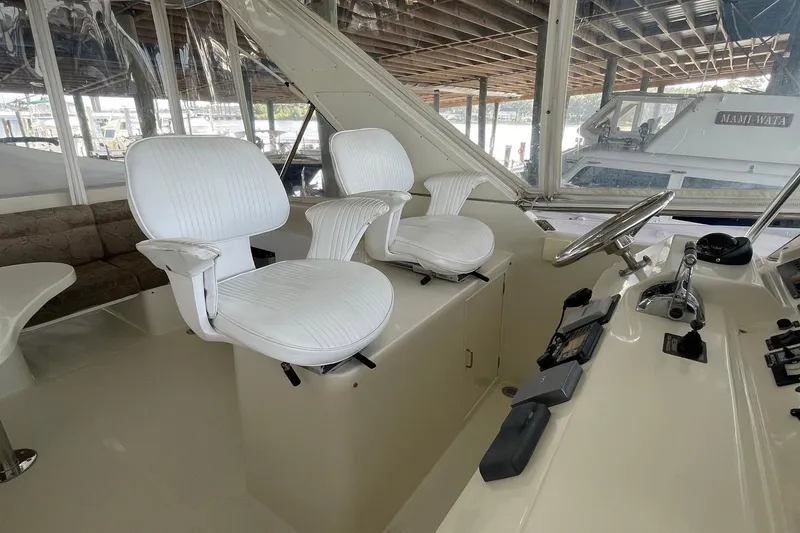 Slide: The Image of Luxurious interior of a 1999 McKinna 57 Pilothouse yacht with plush seating. - 25