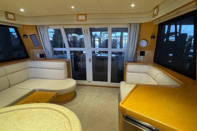 Slide: The Image of Luxurious interior of a 1999 McKinna 57 Pilothouse yacht with wood finishes and modern amenities. - 26