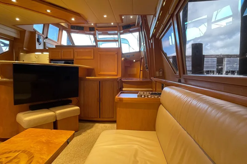 Slide: The Image of Cream leather seating in 1999 McKinna 57 Pilothouse interior, with wooden accents. - 28