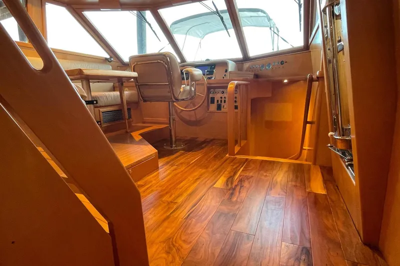 Slide: The Image of Luxurious interior of 1999 McKinna 57 Pilothouse with leather seating and wooden table. - 30