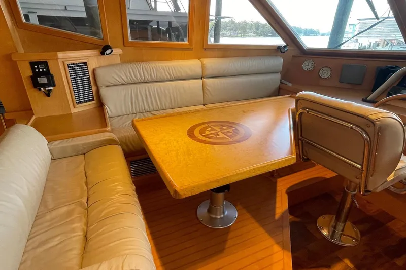 Slide: The Image of 1999 McKinna 57 Pilothouse helm with navigation equipment and leather seating. - 31