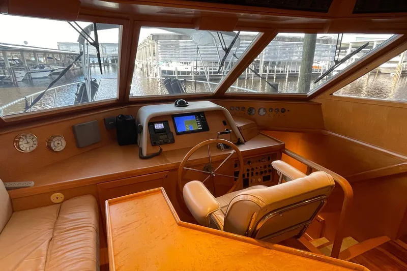 Slide: The Image of Luxurious interior of 1999 McKinna 57 Pilothouse yacht with elegant seating and wooden accents. - 32