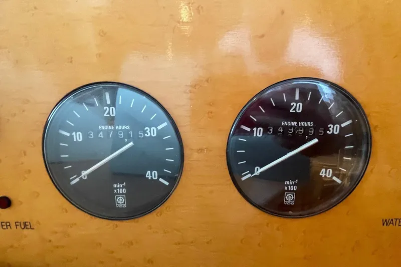 Slide: The Image of Luxurious bedroom interior of 1999 McKinna 57 Pilothouse yacht with navy bedding and orange accents. - 40