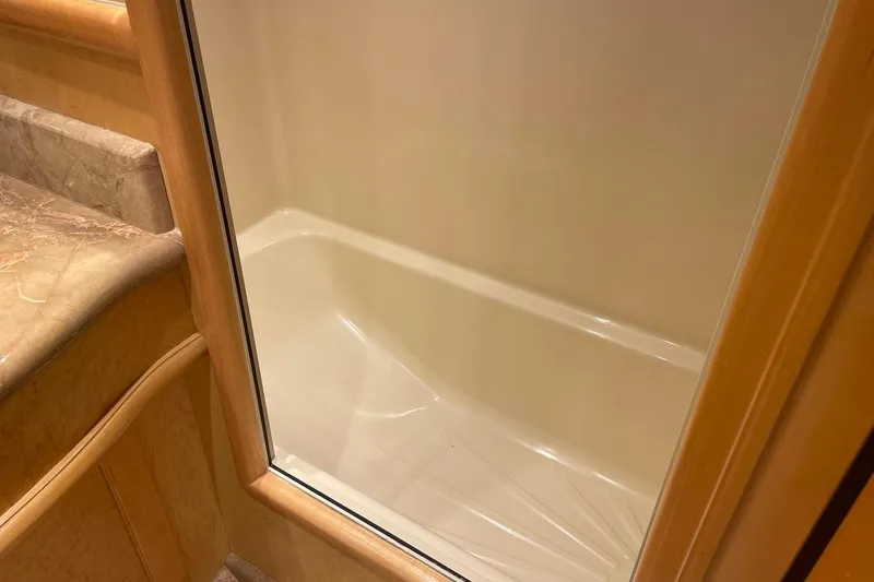 Slide: The Image of 1999 McKinna 57 Pilothouse interior with wooden desk and cabinets. - 46