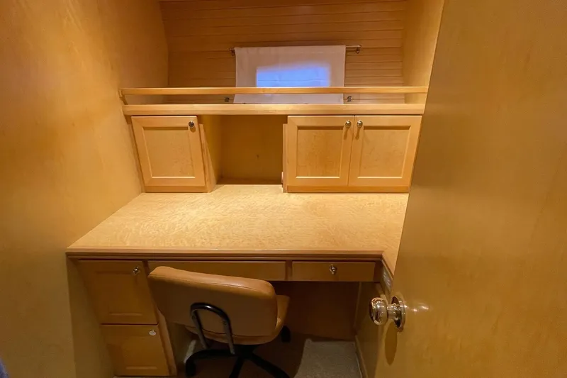Slide: The Image of 1999 McKinna 57 Pilothouse interior with wooden cabinetry and desk area. - 47