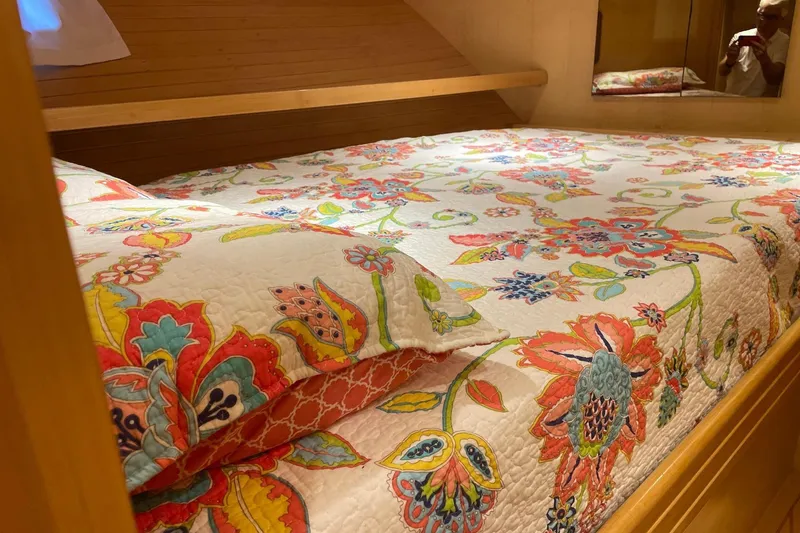 Slide: The Image of Cozy cabin interior of 1999 McKinna 57 Pilothouse with floral bedding and wooden cabinetry. - 53