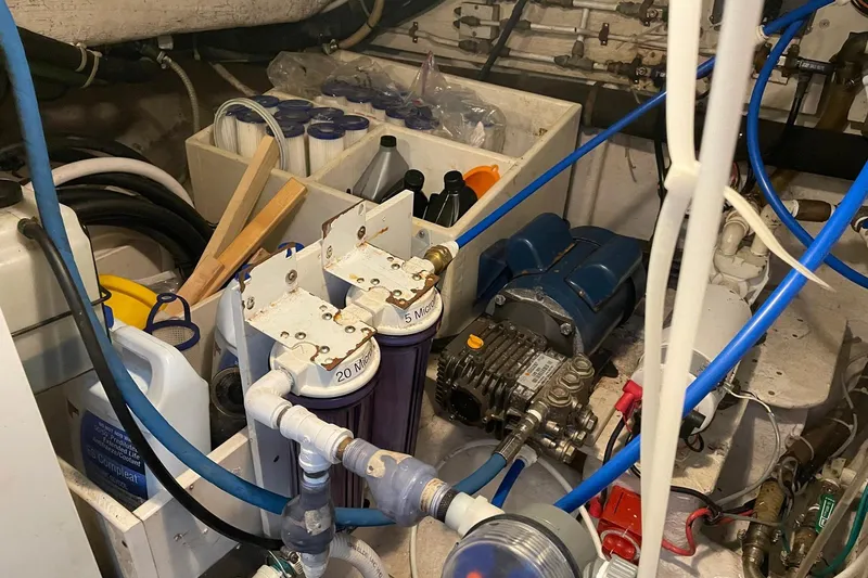 Slide: The Image of Engine room of a 1999 McKinna 57 Pilothouse yacht, showcasing mechanical components. - 55