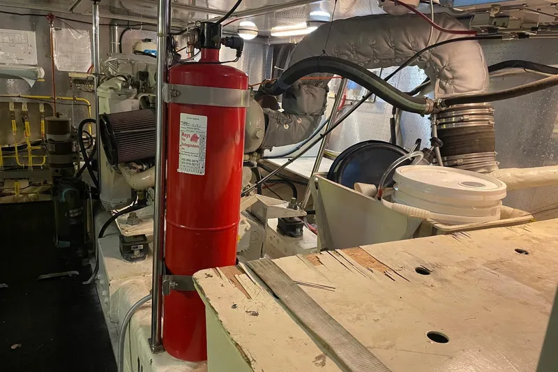 Slide: The Image of Engine room of a 1999 McKinna 57 Pilothouse yacht, showcasing mechanical components. - 57