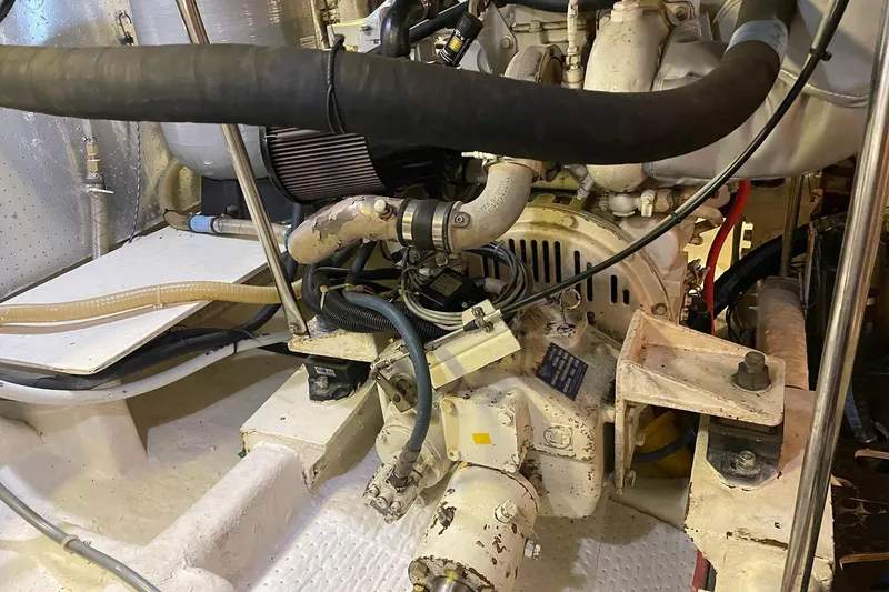 Slide: The Image of Engine room of a 1999 McKinna 57 Pilothouse yacht, showcasing mechanical components. - 58