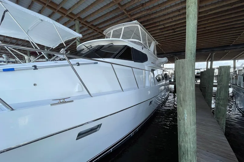 Slide: The Image of 1999 McKinna 57 Pilothouse yacht docked in a covered marina. - 7