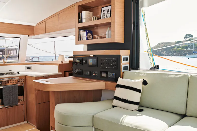 Slide: The Image of Modern Bali CATSMART 2026 yacht interior with light wood cabinetry and cozy seating area. - 12