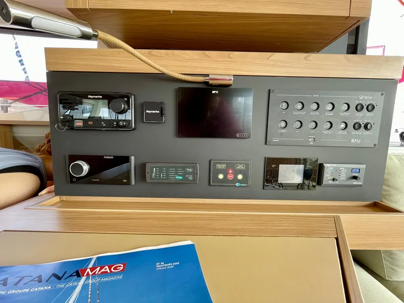 Slide: The Image of Control panel of a 2026 Bali CATSMART yacht with various electronic devices and switches. - 13