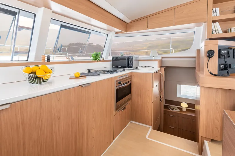 Slide: The Image of Modern yacht kitchen interior with wood finish, featuring appliances and a bowl of lemons. Bali CATSMART 2026. - 18