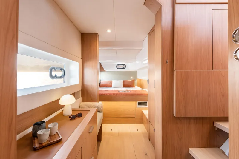Slide: The Image of Luxurious interior of 2026 Bali CATSMART yacht with cozy bedroom and modern wooden furnishings. - 20
