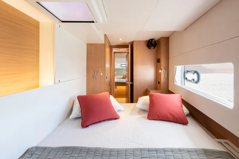 Slide: The Image of Modern cabin interior of 2026 Bali CATSMART yacht with cozy bed and red pillows. - 23